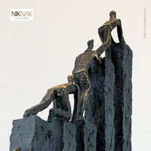 Close up of sculpture - men climbing over blocks